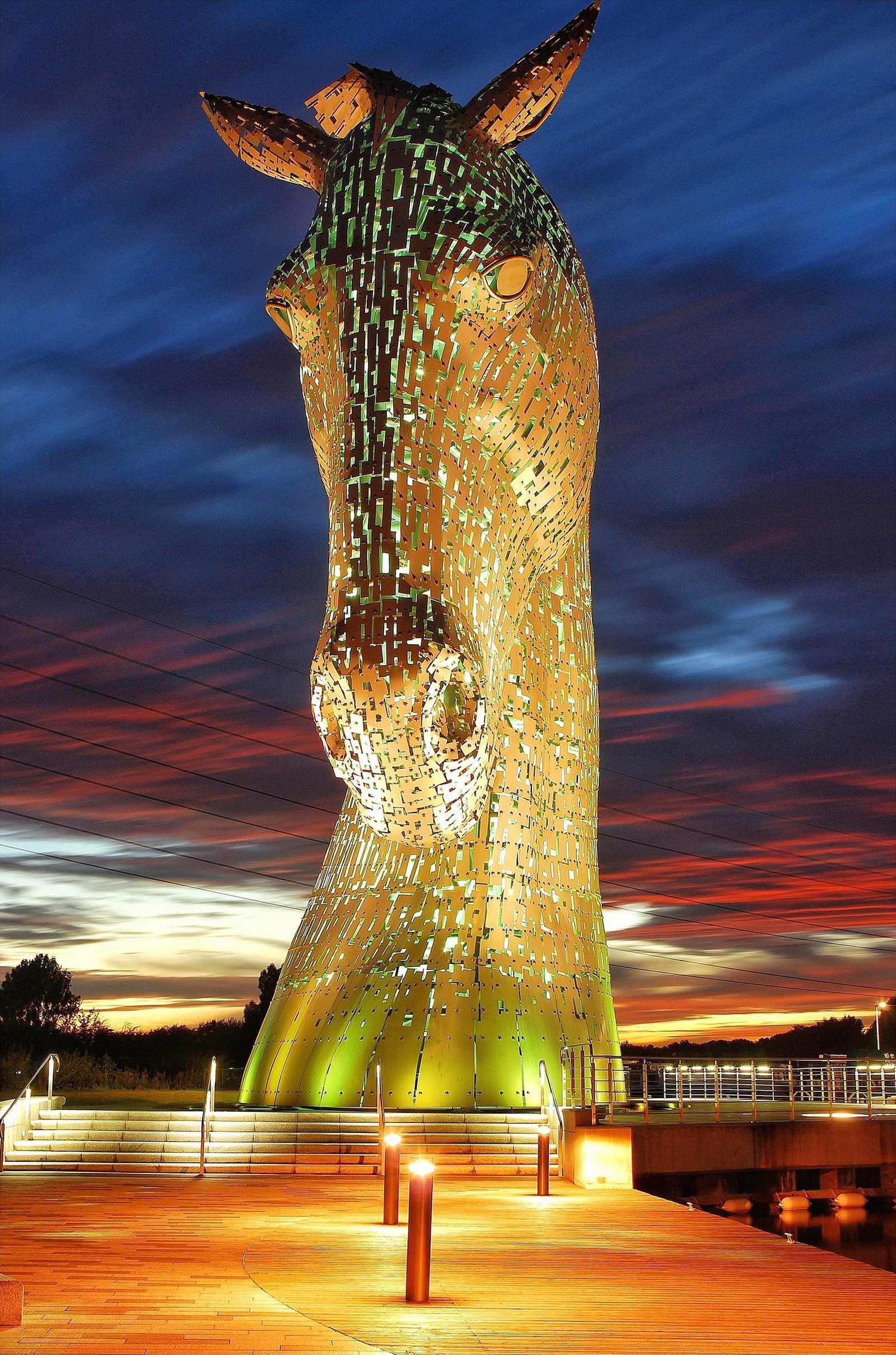The Kelpies lit gold against a night sky