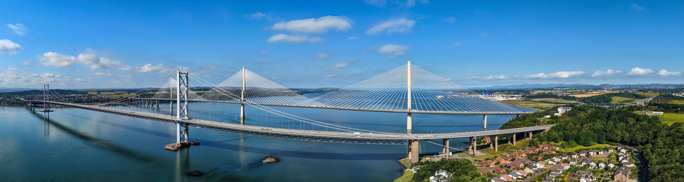 Wide panoramic of the Queensferry Crossing and the Forth bridges